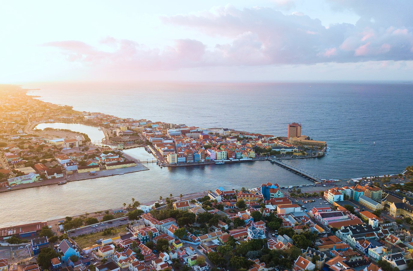 Aerial view of Willemstad, Curaçao, with Punda, the harbour and the Queen Emma Bridge at sunset